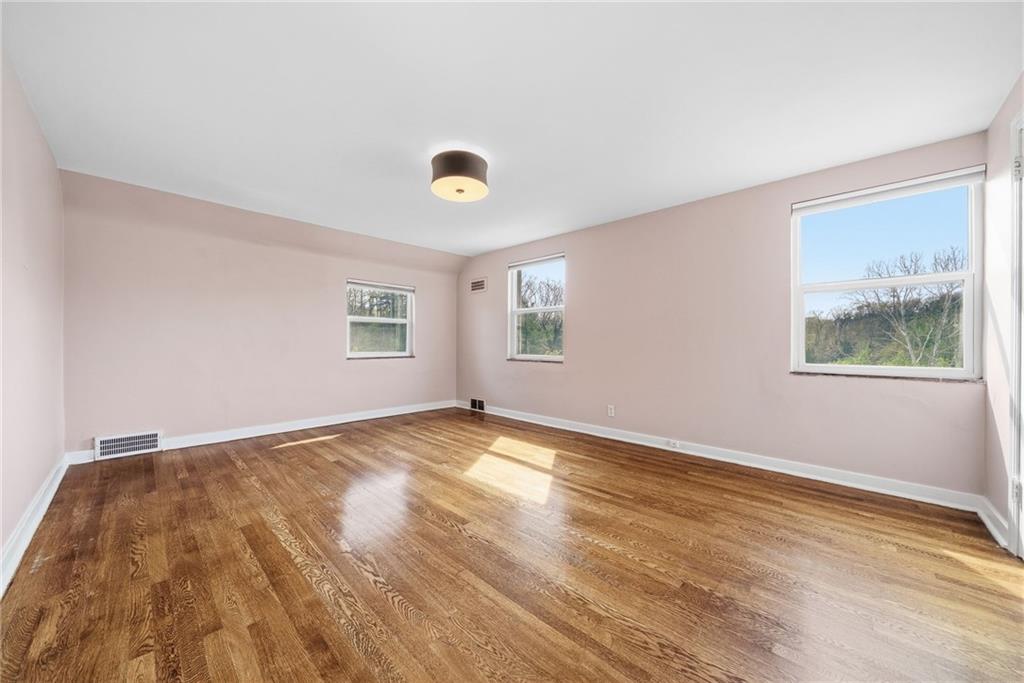 8 Allendale Place Pittsburgh, PA 15228 - Photo 22 of 34 a view of an empty room with window and wooden floor