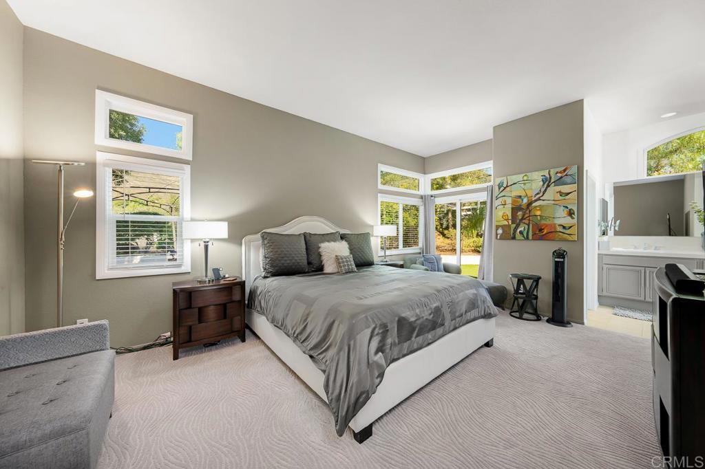 3762 Hidden Ridge Road Jamul, CA 91935 - Photo 13 of 29 a spacious bedroom with a large bed and a flat tv screen on dresser