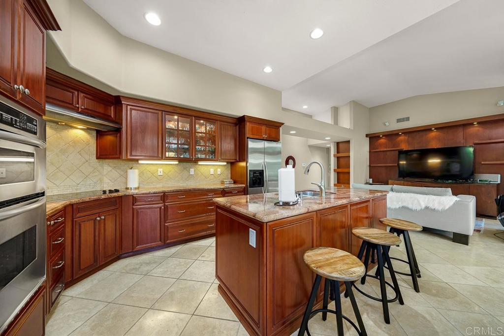 3762 Hidden Ridge Road Jamul, CA 91935 - Photo 8 of 29 a kitchen with stainless steel appliances granite countertop a sink and a refrigerator