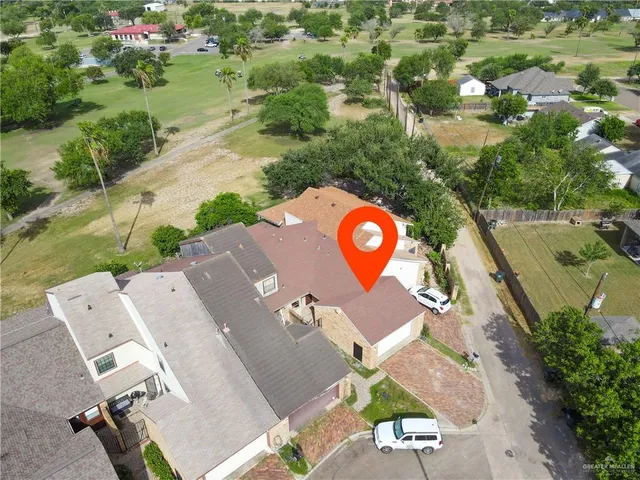 an aerial view of a house with a yard