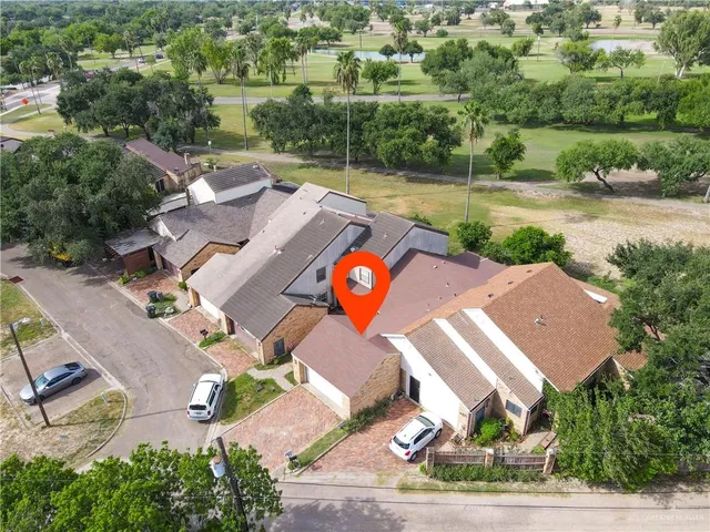 an aerial view of a house with garden space and street view