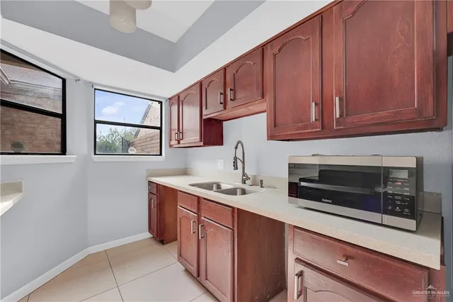 a kitchen with stainless steel appliances granite countertop a sink stove and microwave
