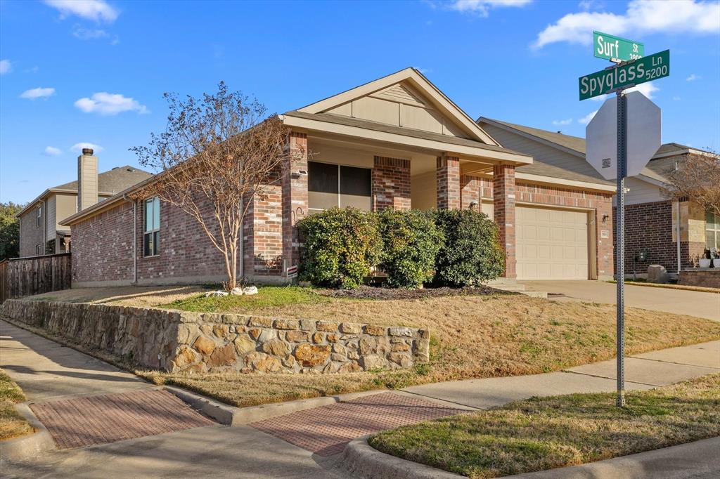 3801 Surf Street Denton, TX 76208 - Photo 1 of 29 Ranch-style house with brick siding, an attached garage, concrete driveway, and a front yard