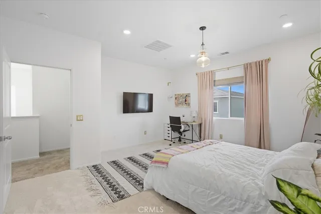 a bedroom with a bed and a table in it