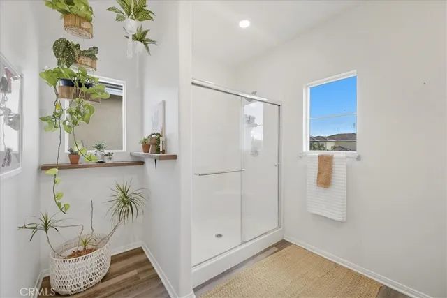 a bathroom with a sink a shower a mirror and vanity