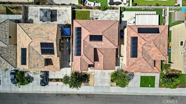 an aerial view of residential houses with outdoor space and seating