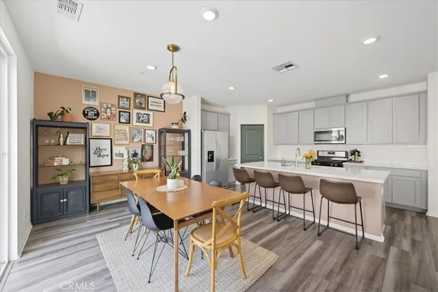 a view of a dining room with furniture large window and wooden floor
