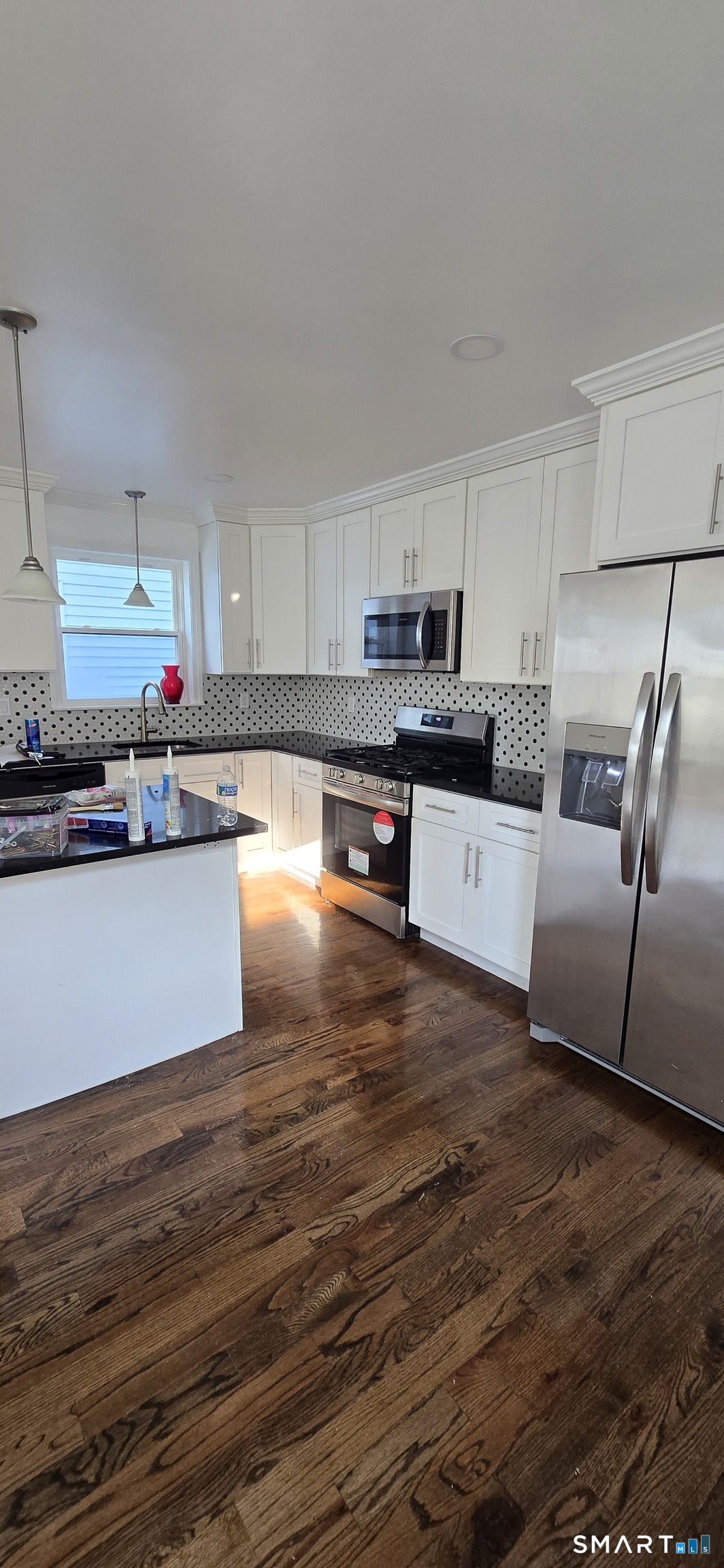 99 Johnson Street, Unit 2 Bridgeport, CT 06604 - Photo 3 of 12 a kitchen with stainless steel appliances a refrigerator sink and microwave