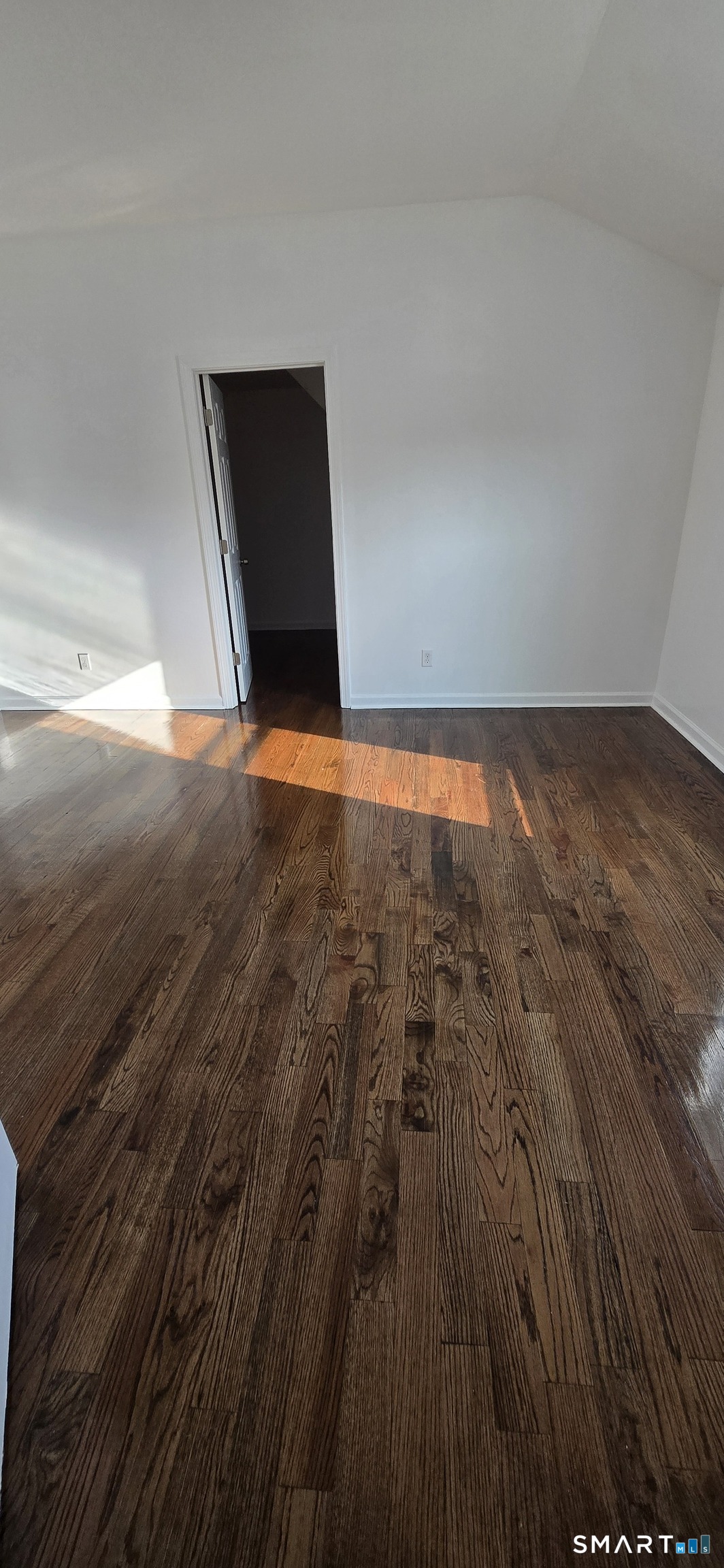 99 Johnson Street, Unit 2 Bridgeport, CT 06604 - Photo 6 of 12 a view of empty room with wooden floor