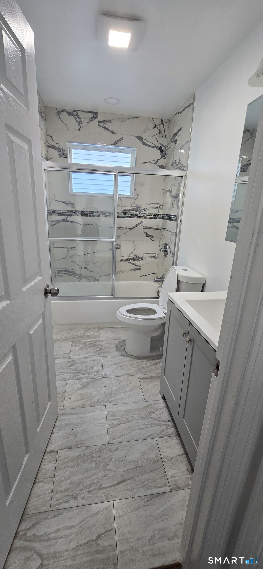 99 Johnson Street, Unit 2 Bridgeport, CT 06604 - Photo 9 of 12 a bathroom with a sink a toilet and shower