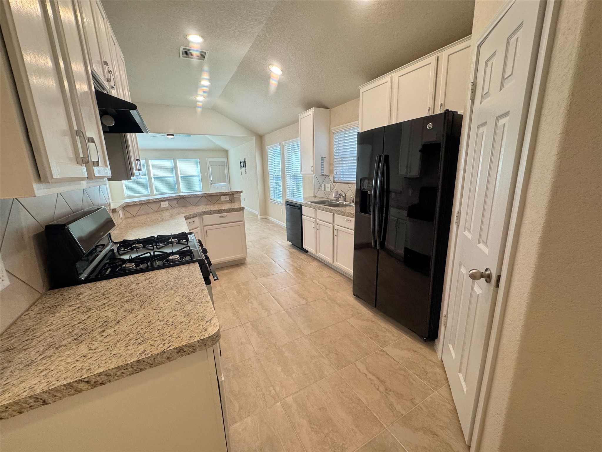 18323 Spruce Tree Line Trail Houston, TX 77084 - Photo 5 of 17 a kitchen with stainless steel appliances granite countertop a refrigerator and a stove