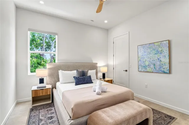 a bed sitting in a bedroom next to a lamp