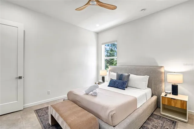 a bedroom with a bed and a painting on the wall