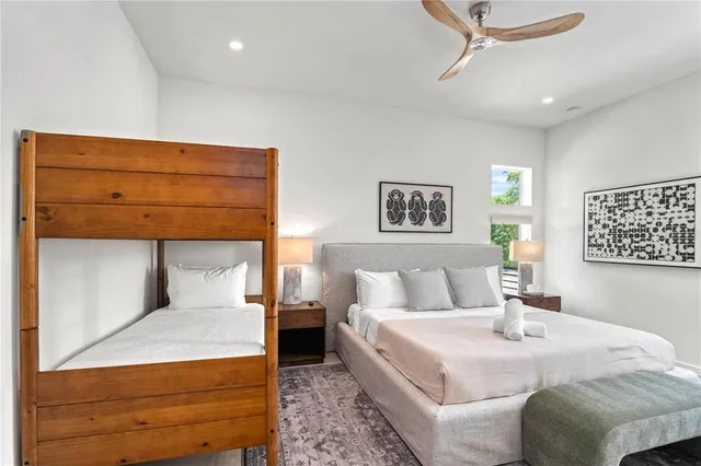 a bedroom with a large bed and a large window