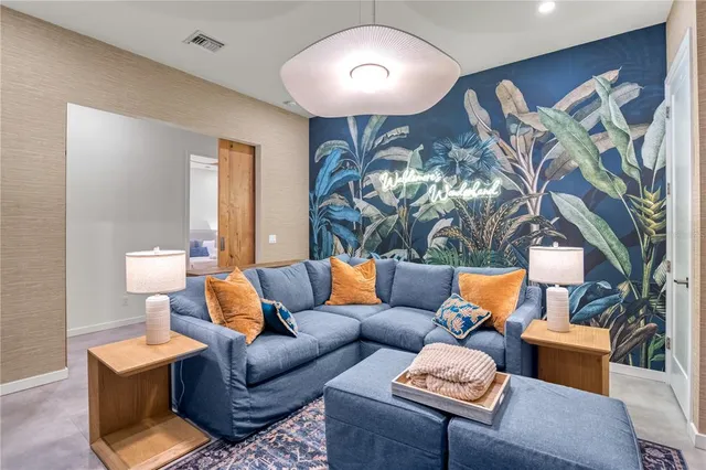 a living room with furniture a rug and a flat screen tv