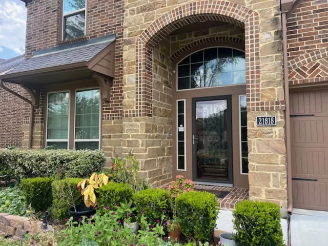 front view of a brick house with a large door