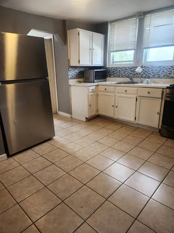 a kitchen with stainless steel appliances granite countertop a refrigerator sink and cabinets