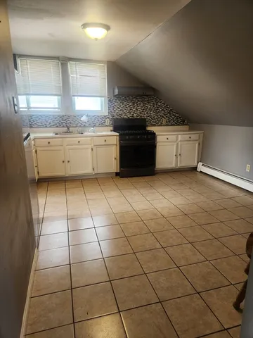 a kitchen with stainless steel appliances a sink a stove a microwave and cabinets