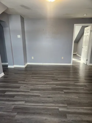a view of room with window and wooden floor