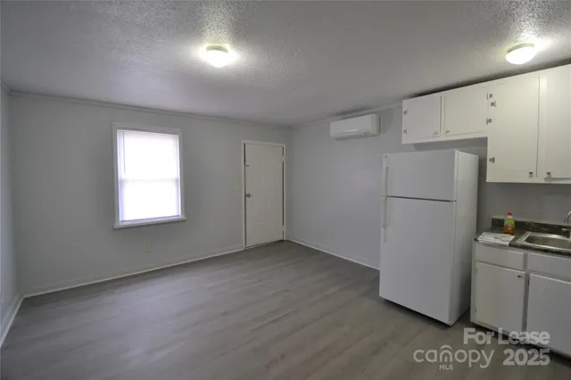 a view of kitchen with hardwood floor and window