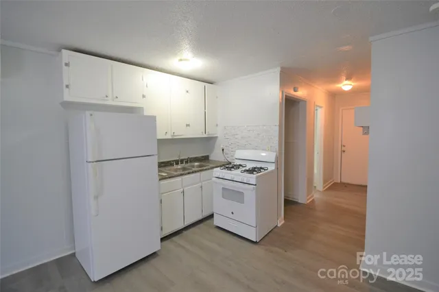 a kitchen with cabinets and stainless steel appliances