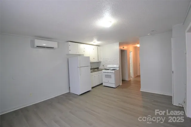 a view of a kitchen with wooden floor