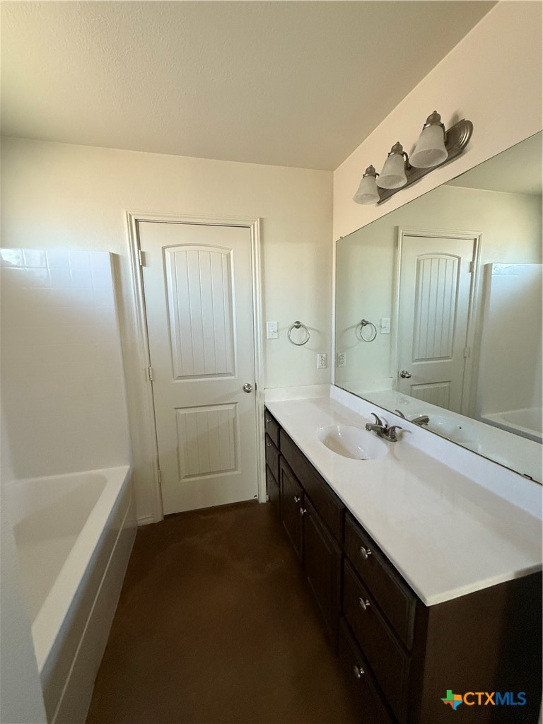 4405 Texas Rangers Drive Killeen, TX 76549 - Photo 5 of 22 a bathroom with a double vanity sink a mirror and a bathtub