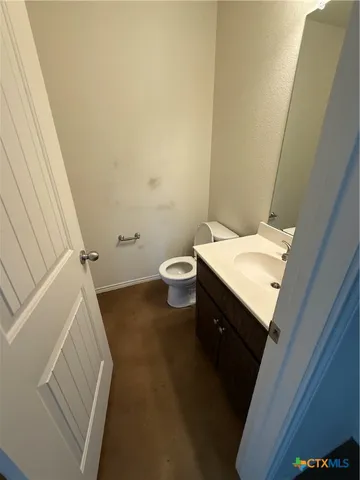 an empty room with wooden floor and windows in it