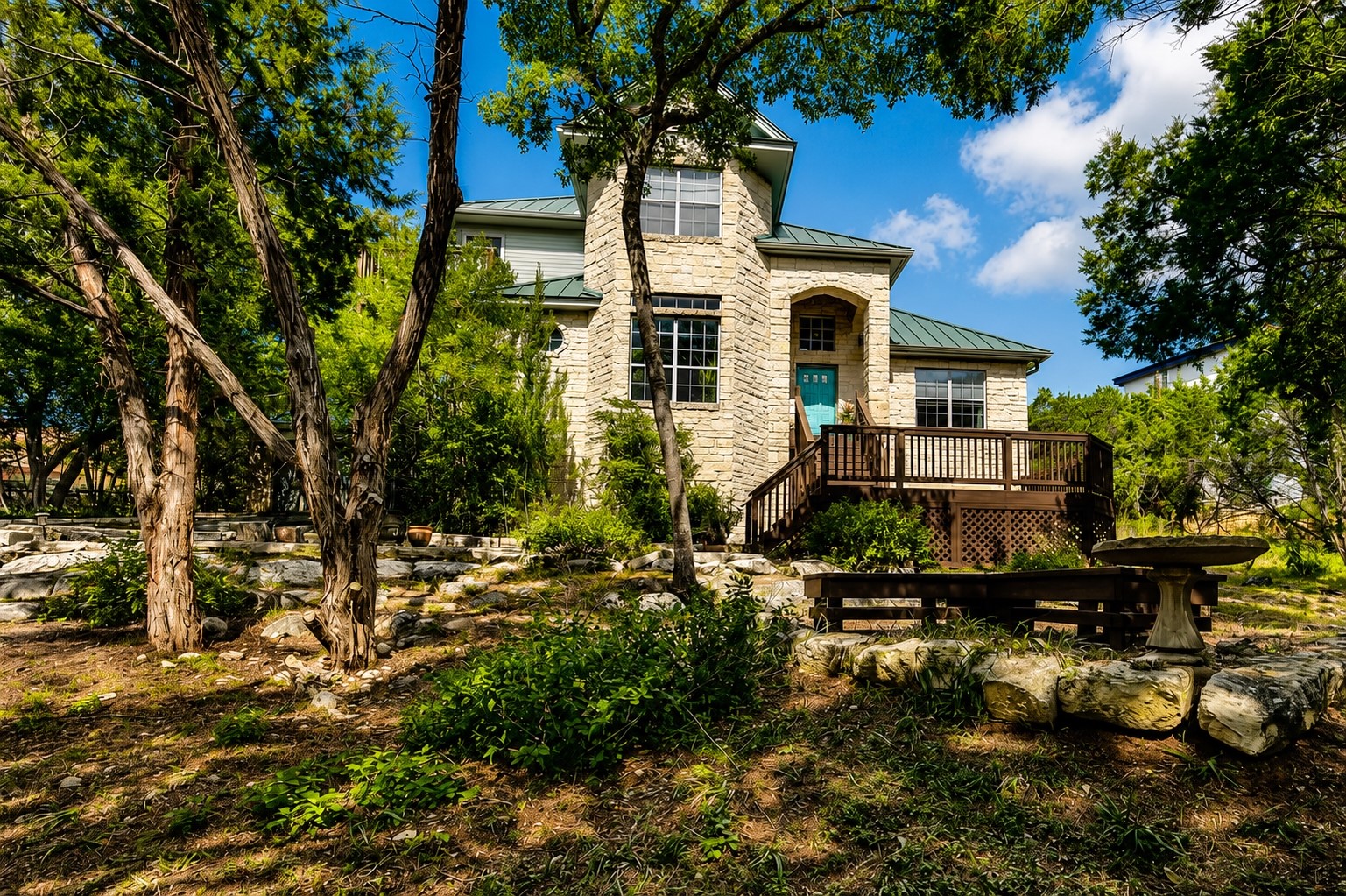 1602 Wild Basin Ledge Austin, TX 78746 - Photo 5 of 5 Stone façade residence featuring a prominent turquoise entry door