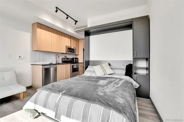 a bedroom with a large bed and a window