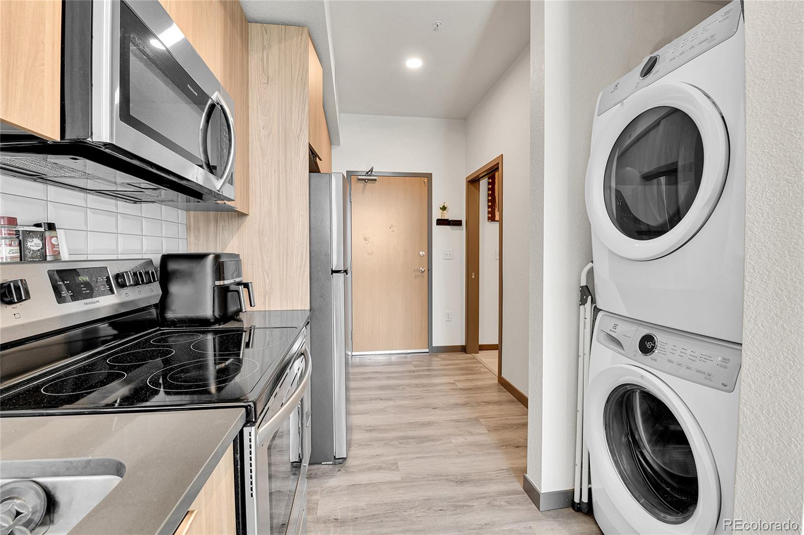 603 Inca Street, Unit 301 Denver, CO 80204 - Photo 12 of 12 a kitchen with a stove sink and a washer dryer