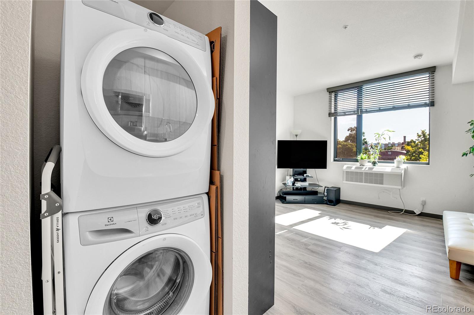 603 Inca Street, Unit 301 Denver, CO 80204 - Photo 20 of 21 a living room with furniture and a flat screen tv