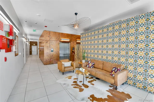 a living room with furniture and a chandelier