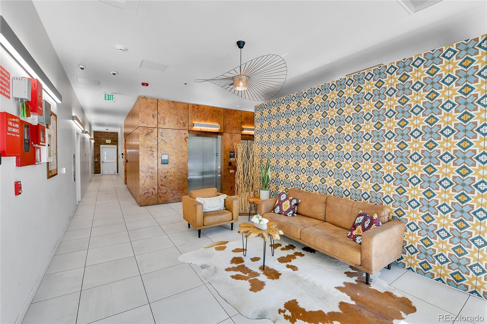 603 Inca Street, Unit 301 Denver, CO 80204 - Photo 3 of 21 a living room with furniture and a chandelier