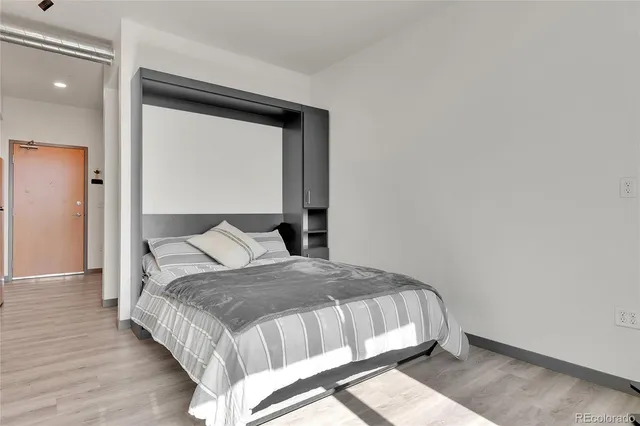 a bedroom with a bed and a mirror