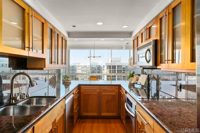 a kitchen with large windows sink and large window