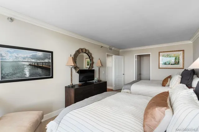 a bedroom with a bed and a television