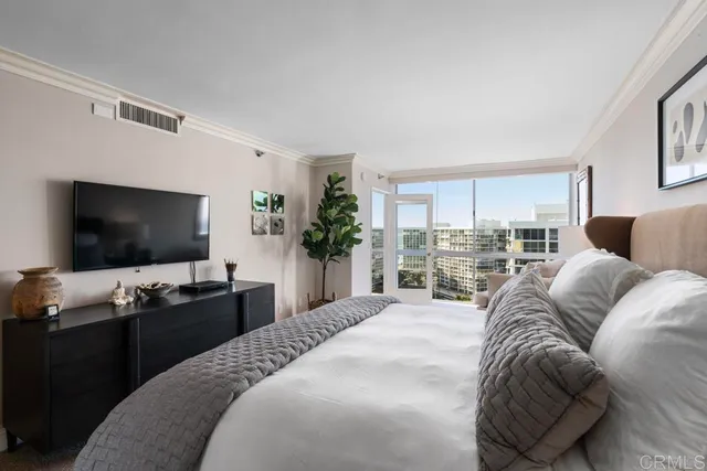 a bedroom with a bed and a flat screen tv