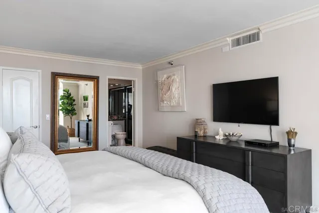 a bedroom with a bed and a flat screen tv