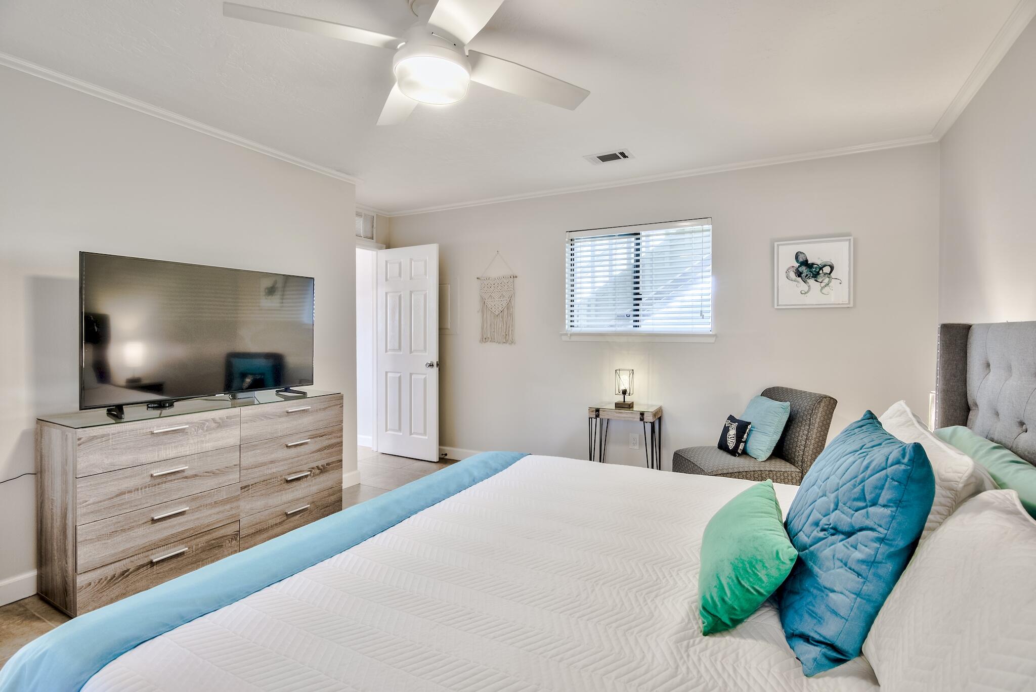 64 Cross Creek Road, Unit 11 Miramar Beach, FL 32550 - Photo 12 of 20 a bedroom with a bed and a flat screen tv in a dresser