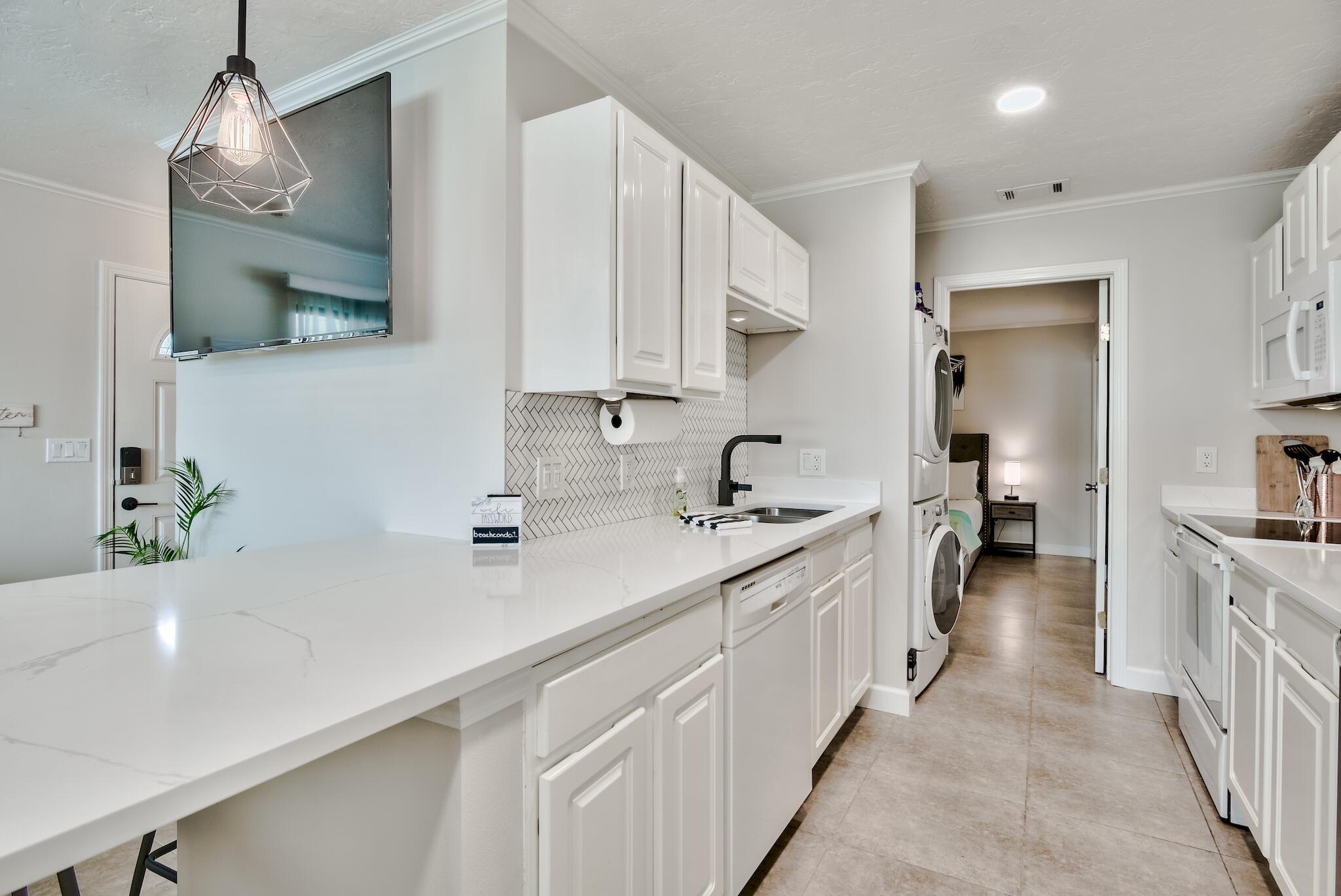 64 Cross Creek Road, Unit 11 Miramar Beach, FL 32550 - Photo 5 of 20 a kitchen with sink stove and cabinets