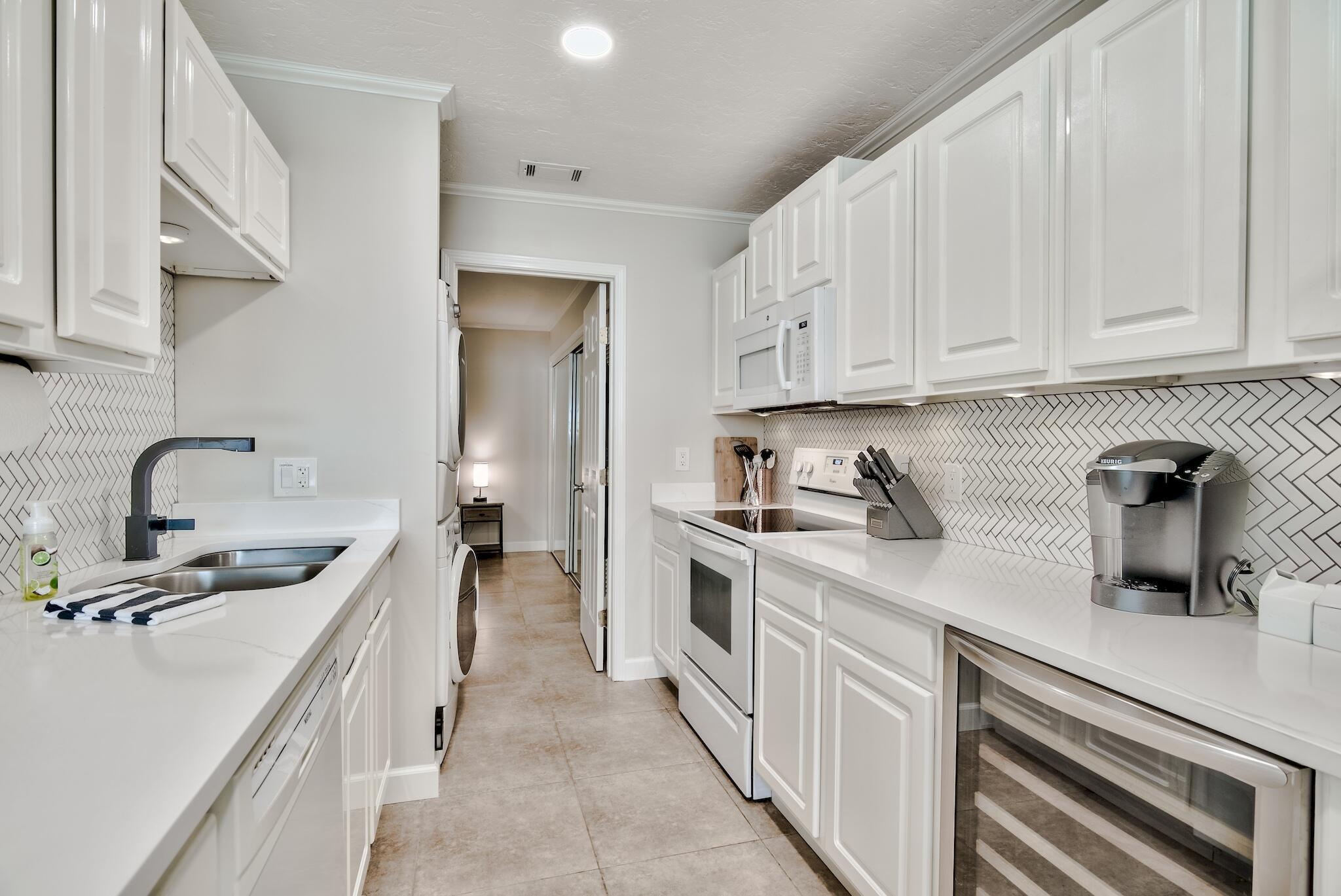 64 Cross Creek Road, Unit 11 Miramar Beach, FL 32550 - Photo 8 of 20 a kitchen with a sink stove and cabinets