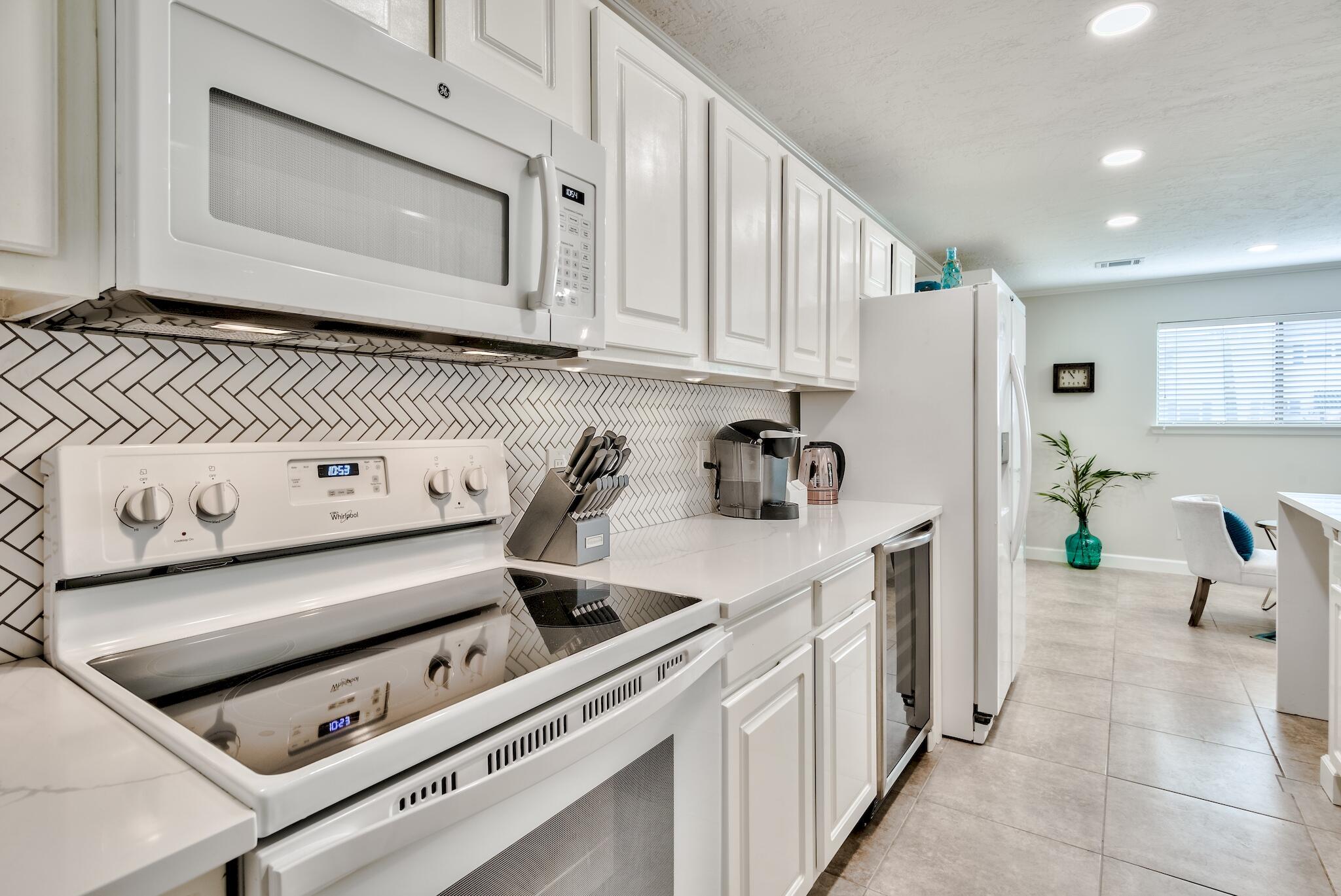 64 Cross Creek Road, Unit 11 Miramar Beach, FL 32550 - Photo 9 of 20 a kitchen with a stove and a microwave