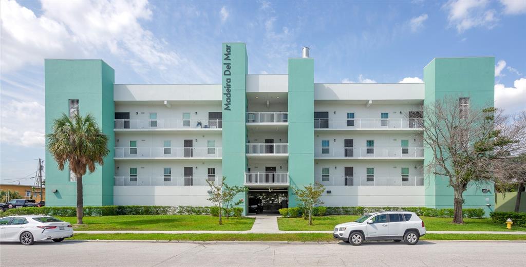 15305 1st Street East, Unit 202 Madeira Beach, FL 33708 - Photo 1 of 40 a view of a car parked in front of a building