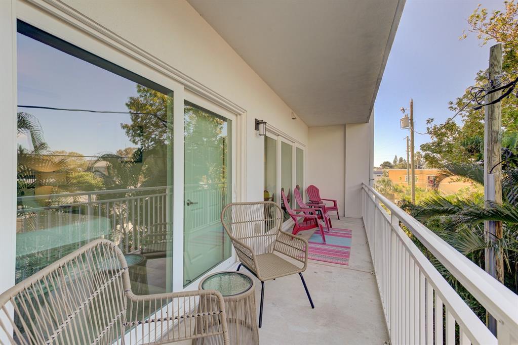 15305 1st Street East, Unit 202 Madeira Beach, FL 33708 - Photo 12 of 40 a view of a balcony with chair and wooden floor