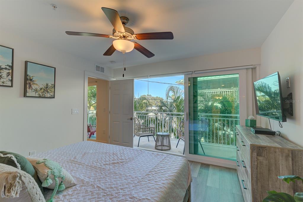 15305 1st Street East, Unit 202 Madeira Beach, FL 33708 - Photo 15 of 40 a bedroom with furniture and a large window