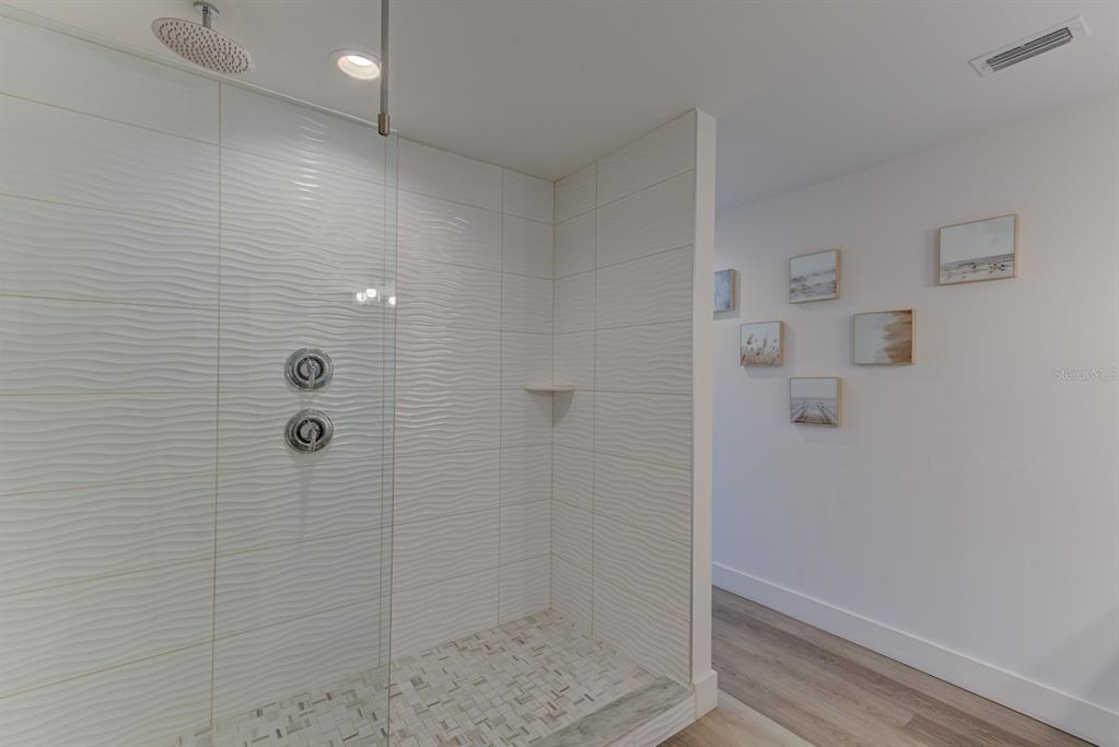 15305 1st Street East, Unit 202 Madeira Beach, FL 33708 - Photo 17 of 40 a bathroom with a shower