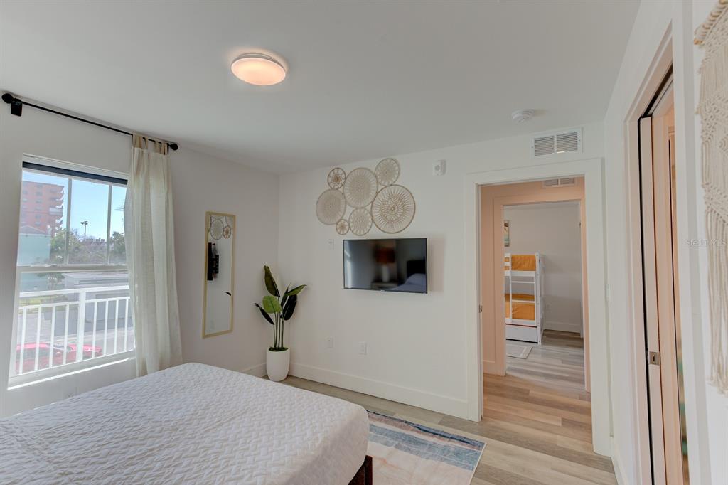 15305 1st Street East, Unit 202 Madeira Beach, FL 33708 - Photo 22 of 40 a bedroom with a bed and a window