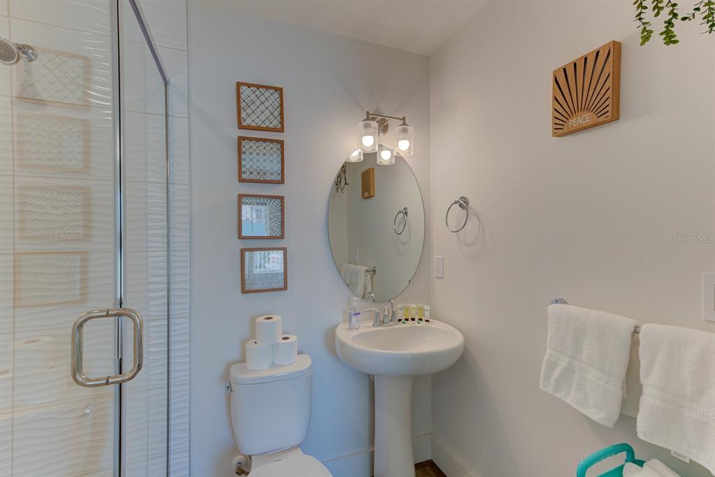 15305 1st Street East, Unit 202 Madeira Beach, FL 33708 - Photo 23 of 40 a bathroom with a sink toilet and shower
