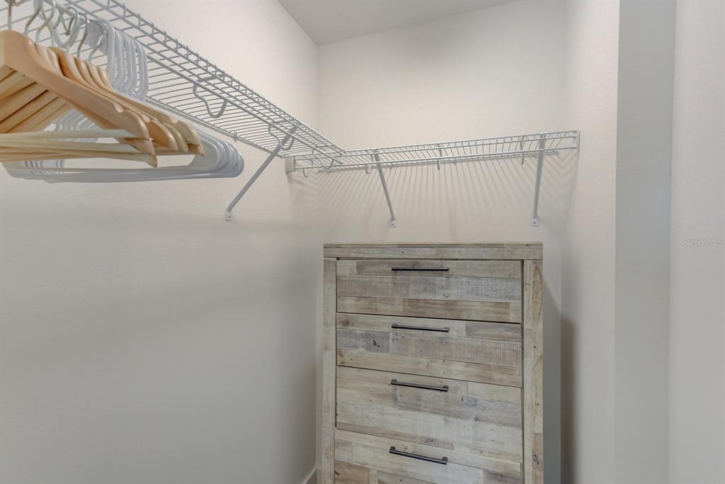 15305 1st Street East, Unit 202 Madeira Beach, FL 33708 - Photo 24 of 40 a view of walk in closet with empty racks